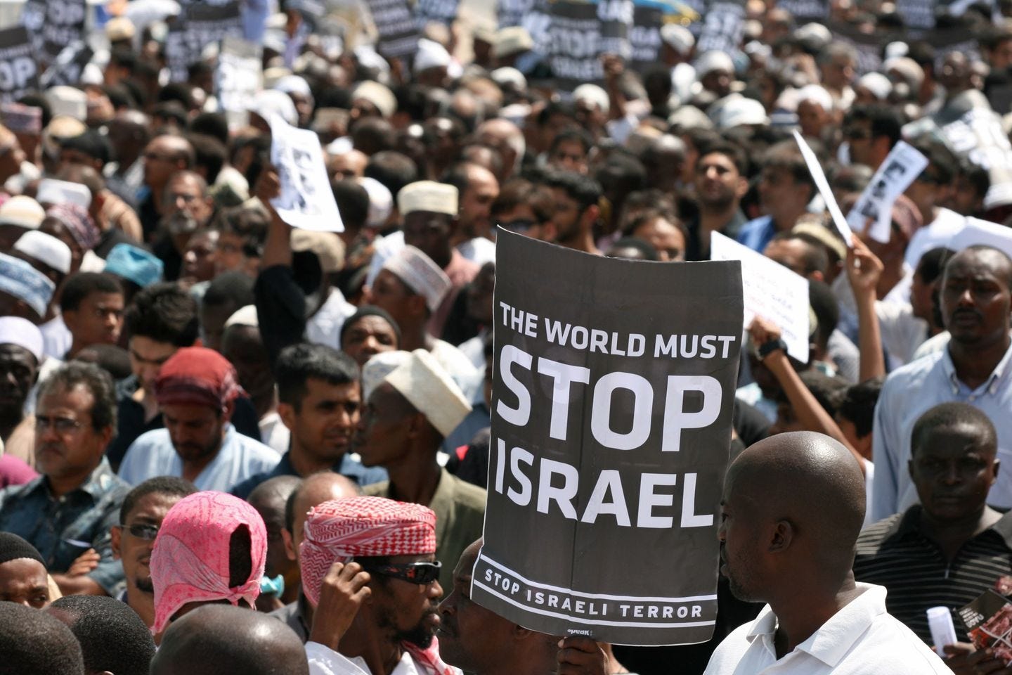 May be an image of 3 people, people standing, crowd and text that says 'THE WORLD STOP MUST ISRAEL STOP ISRAELI TERROR peak!'