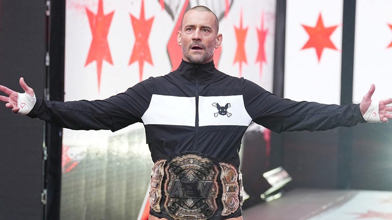 CM Punk wearing former AEW World Championship title belt