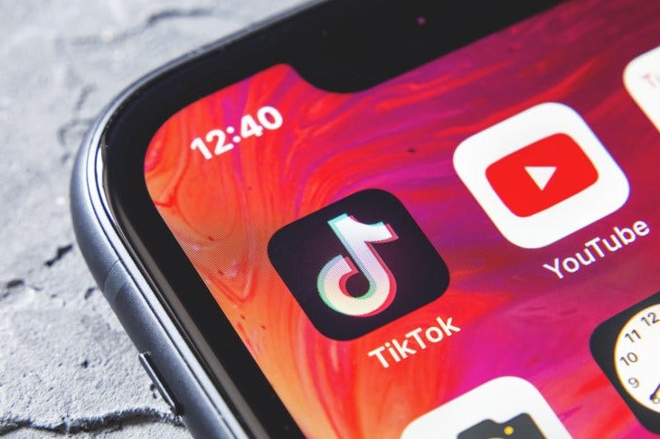 TikTok and YouTube apps on screen iphone xr, close up