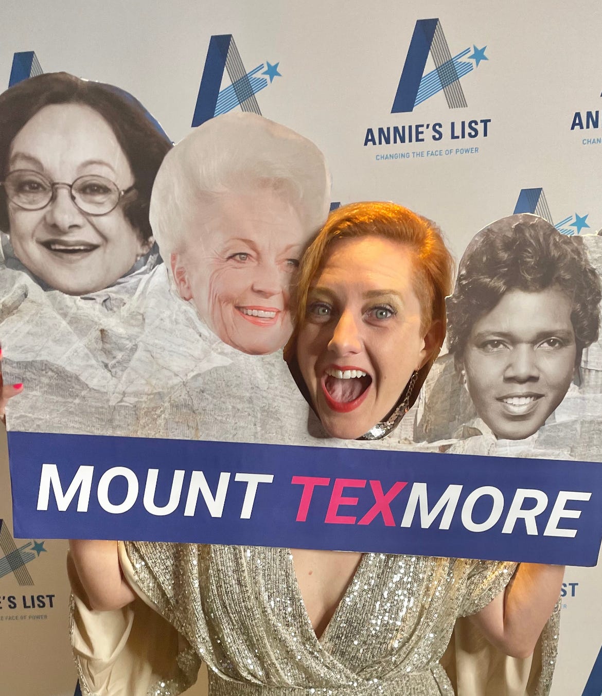 Against the backdrop of a repeating Annie's List logo, Becky places her ecstatic, smiling face into a "Mount Texmore" photo prop alongside the faces of Norma Rangel, Ann Richards, and Barbara Jordan