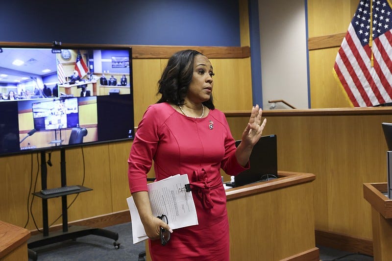 Fulton County District Attorney Fani Willis steps away from the stand after testifying during a hearing on the Georgia election interference case, Thursday, Feb. 15, 2024, in Atlanta. The hearing is to determine whether Willis should be removed from the case because of a relationship with Nathan Wade, special prosecutor she hired in the election interference case against former President Donald Trump. (Alyssa Pointer/Pool Photo via AP)