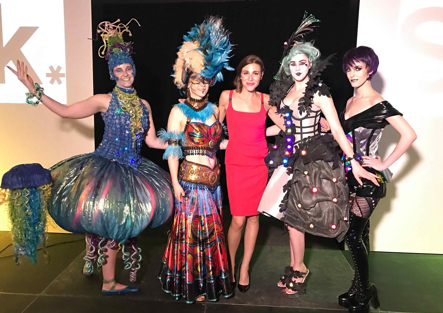 Amanda Cosco posing with four models in costume from MakeFashion 
