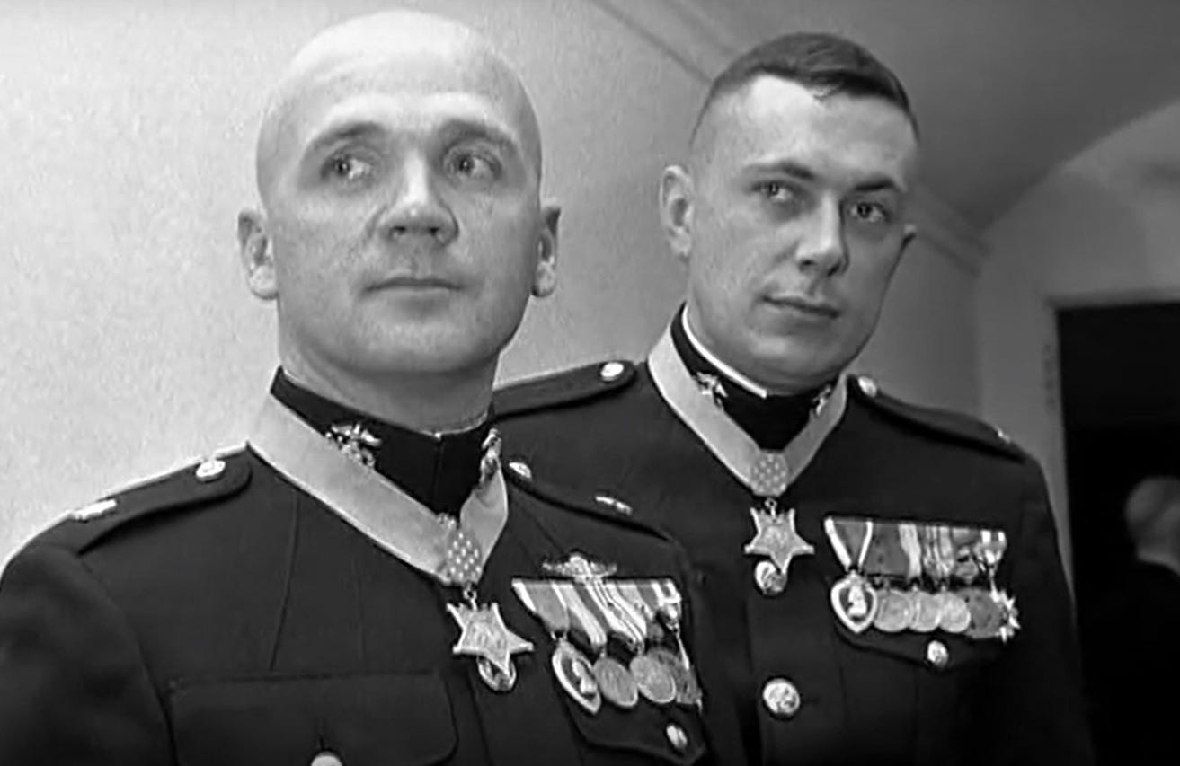 Photo of Robert Modrzejewski and John McGinty.  Both men are in uniform and wearing their Medal.