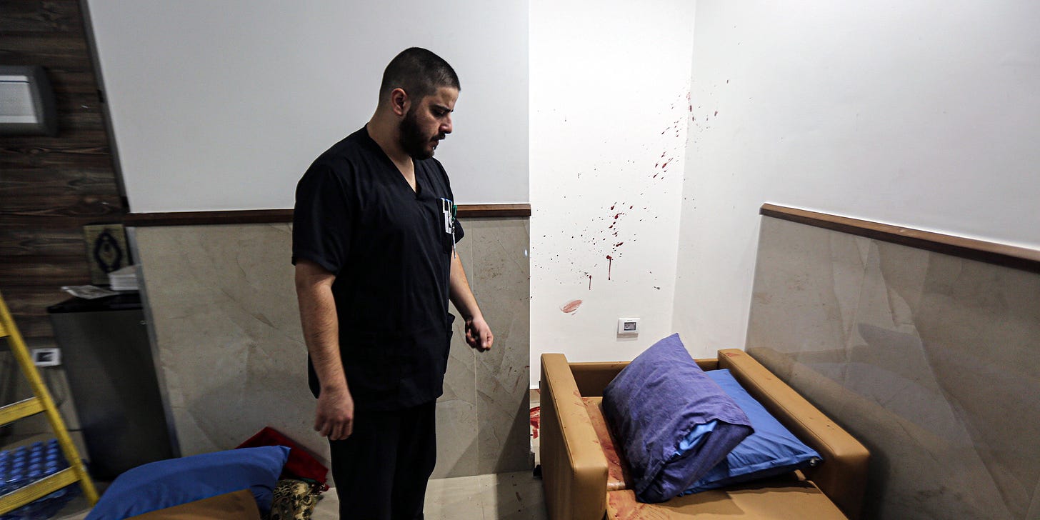 (EDITOR'S NOTE : Image contains graphic content) A staff member of Ibn Sina Hospital seen looking on a blood-stained pillow following a deadly Israeli military raid in the West Bank town of Jenin. Armed Israeli undercover forces disguised as women and medical workers stormed the hospital on Tuesday, killing three Palestinian militants. The Palestinian Health Ministry condemned the incursion on a hospital. (Photo by Nasser Ishtayeh / SOPA Images/Sipa USA)(Sipa via AP Images)