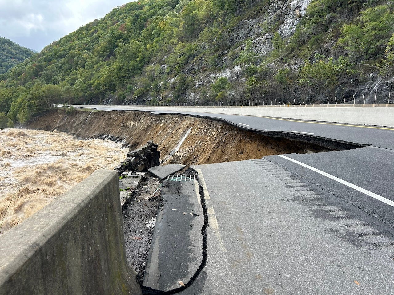 highway crumbled into flood waters