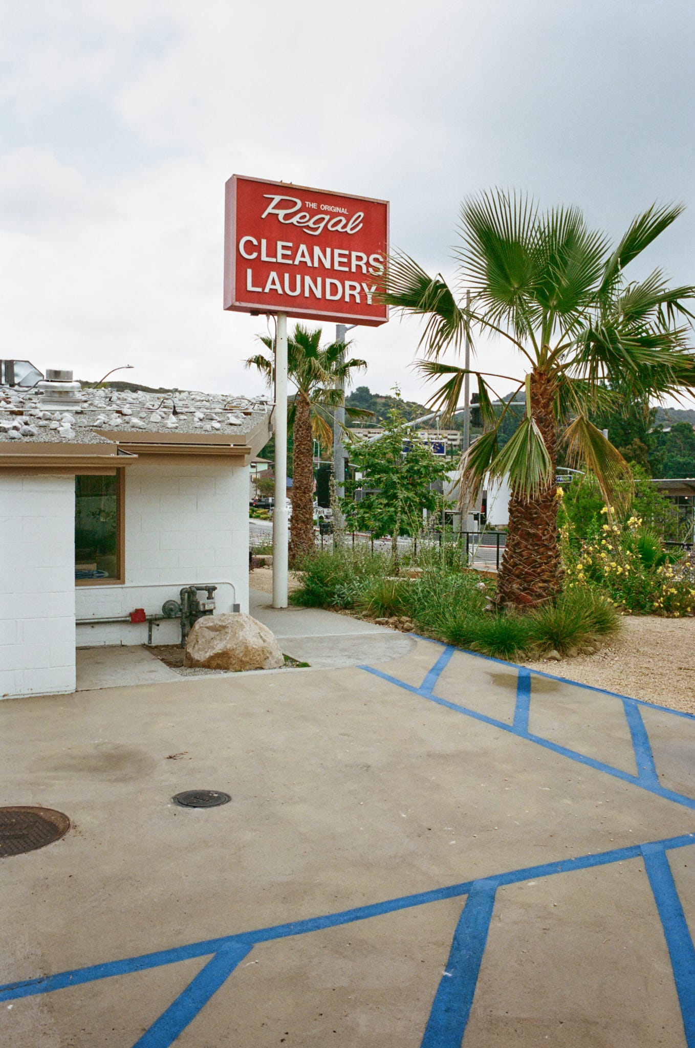 The view of The Original Regal dry cleaners sign from the parking lot