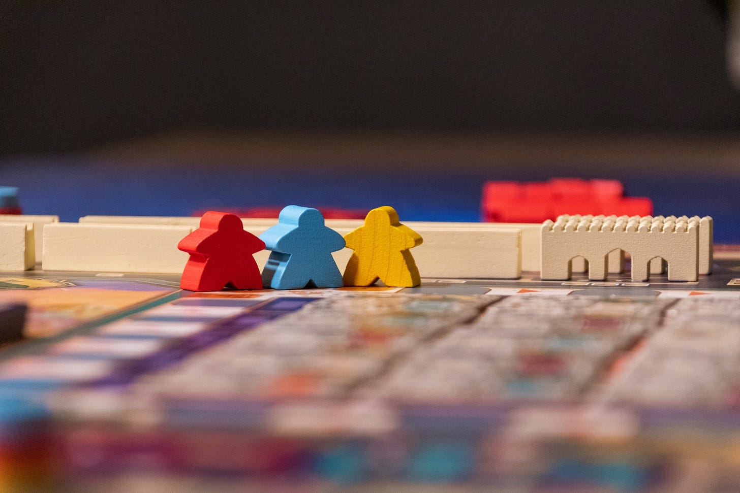 Game pieces in several colors standing on a game board.