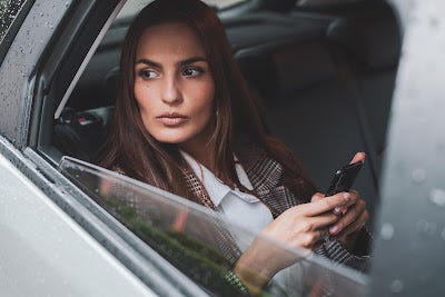 Woman looking out a car window.