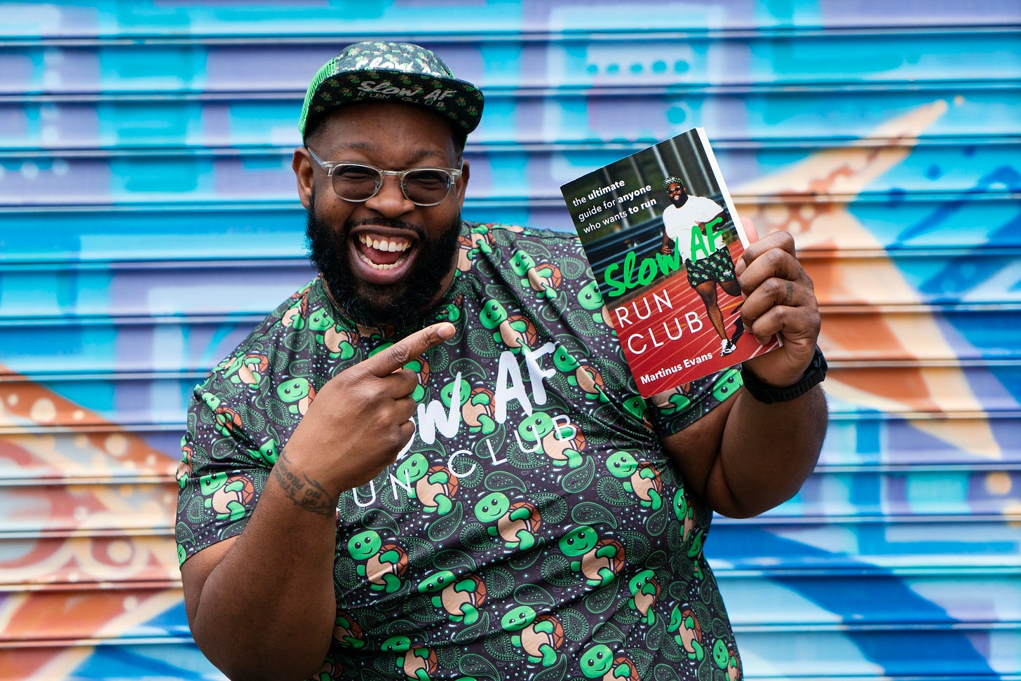 Martinus Evans with his book, Slow AF Run Club