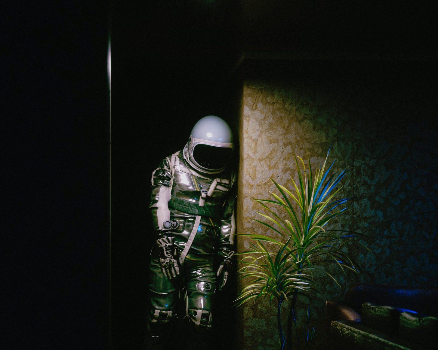 a man in a space suit standing in a doorway