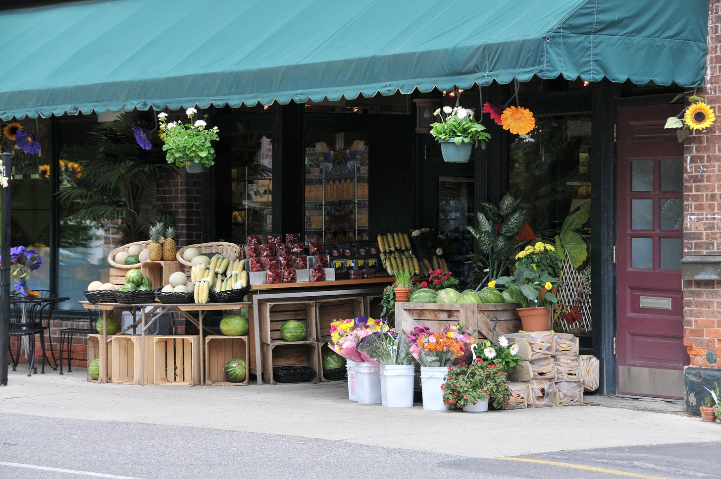 A neighborhood grocery store with a display of produce.