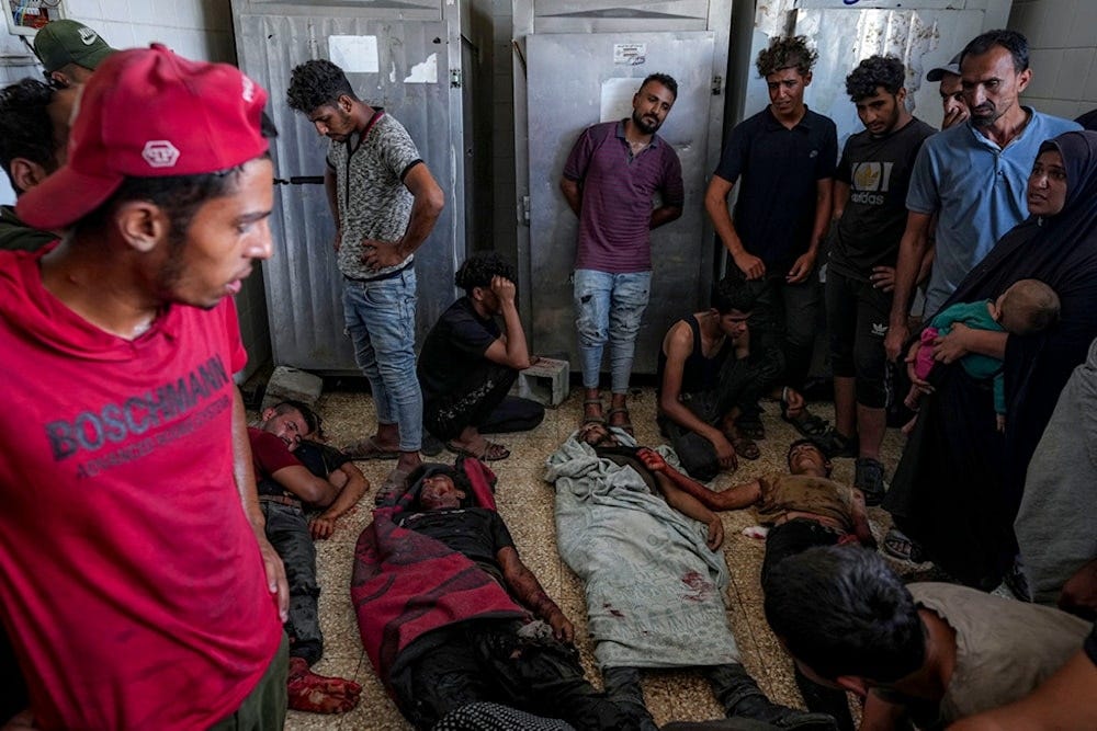 Palestinians mourn their relatives killed in the Israeli bombardment of the Gaza Strip at a hospital morgue in Deir al-Balah, Wednesday, August 28, 2024 (AP)