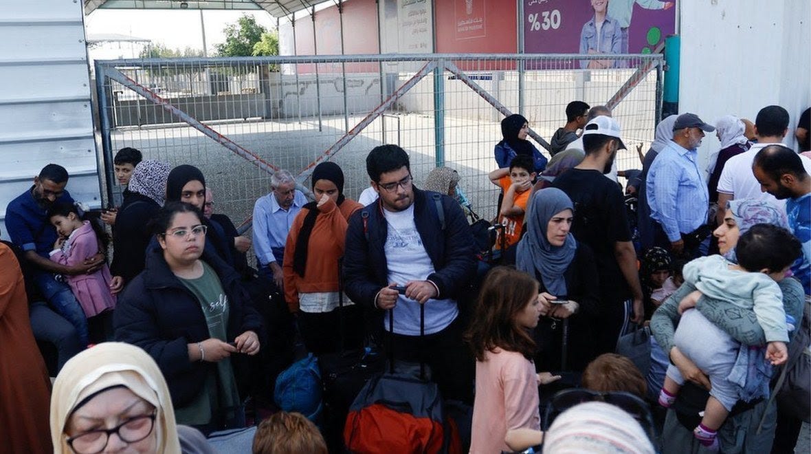 Palestinians wait at the Rafah crossing