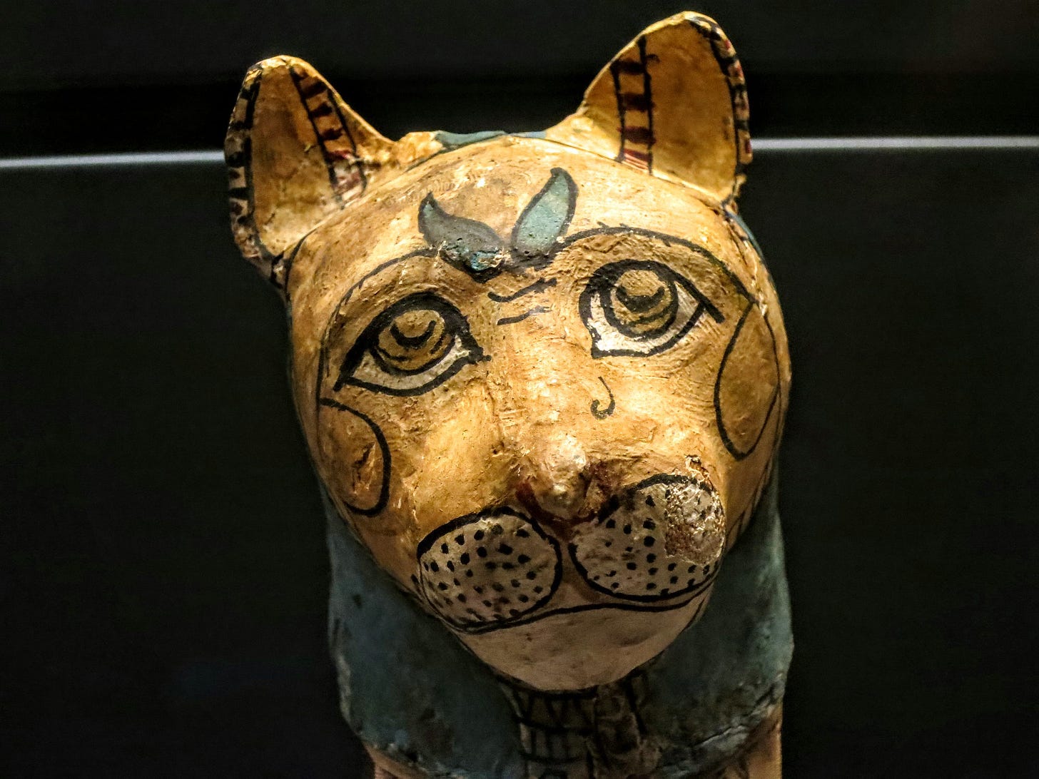 A Egyptian mummified cat (664-332 BCE) now within the Department of Egyptian Antiquities, Louvre Museum, Paris, France (AF 9461) made with linen, paint, stucco, and fabric (Image by Karl Steel via Flickr). 
