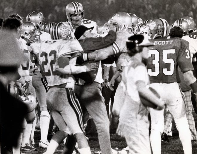 Ohio State coach Woody Hayes is restrained by guard Ken Fritz after he struck a Clemson player during the Gator Bowl in 1978.