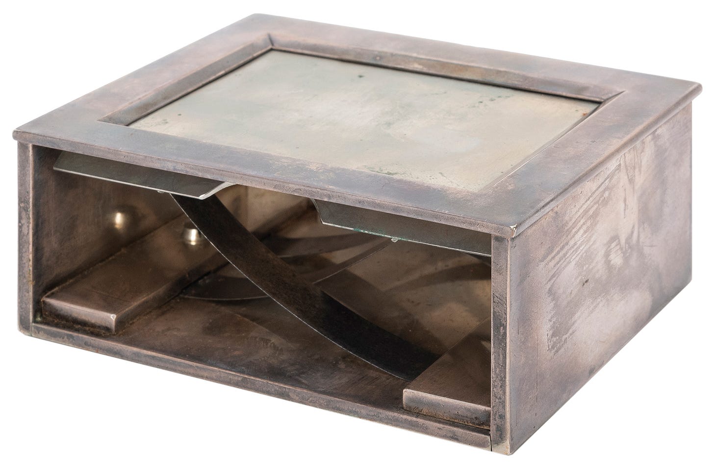 A silver box with one open side, exposing the inner workings of the mechanism.