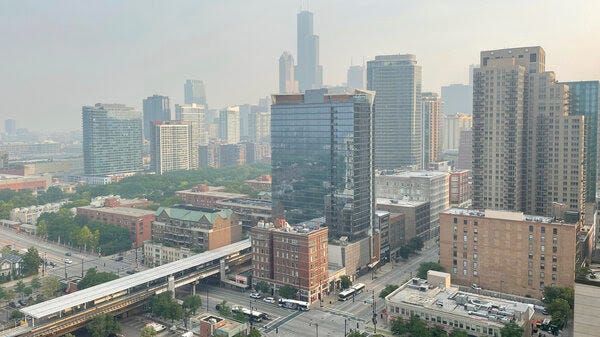 Haze from Canadian wildfires blankets the Chicago skyline as seen from the city's South Loop neighborhood on Wednesday.