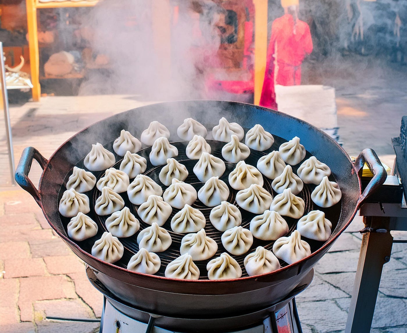Image of a large wok on a stand in the street licensed from Adobe Stock