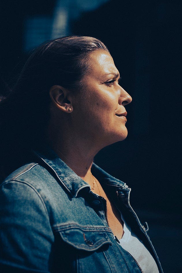 side profile of Caroline Darian against a black background