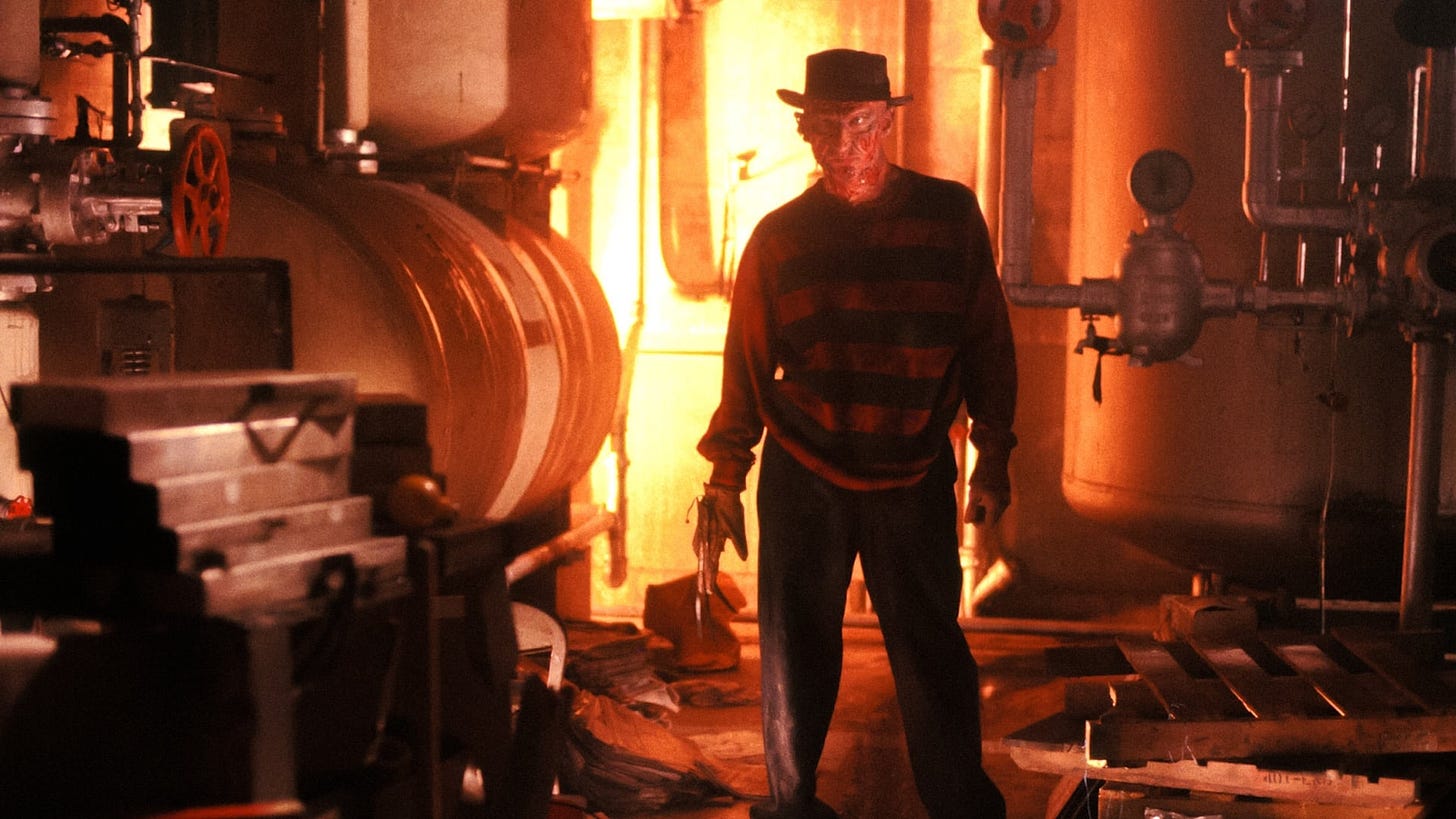 A Nightmare on Elm Street | Still features Robert Englund as Freddy Krueger against a boiler room in flames.