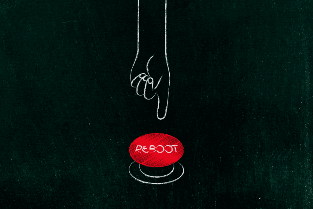 hand about to push a big red reboot button to manage stress, thoughts and emotions
