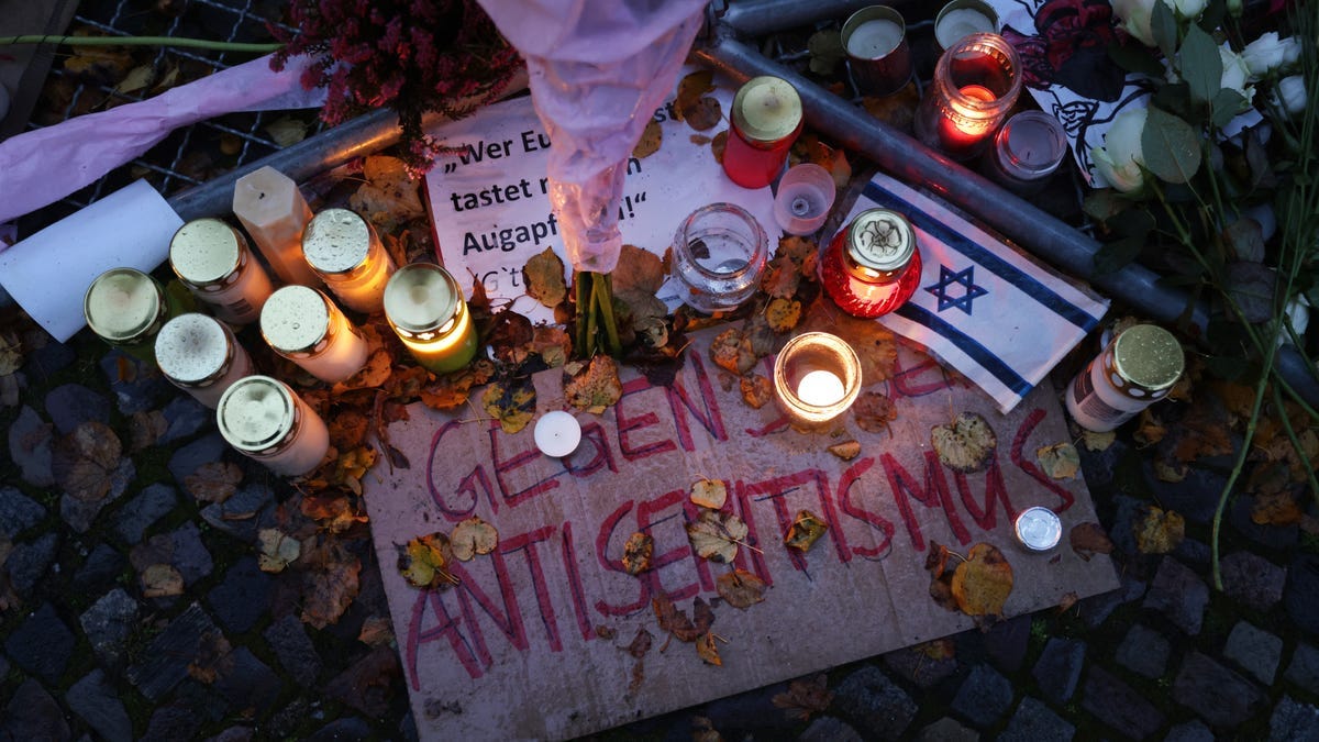 BERLIN, GERMANY - OCTOBER 20: Candles left by participants stand over a sign that reads: "Against Antisemitism" during a vigil outside the Kahal Adass Jisroel Orthodox Jewish community center on October 20, 2023 in Berlin, Germany. Assailants threw Molotov cocktails at the building in the early hours of October 15 but caused no damage. Emotions among Berlin's Jewish and Arab and Muslim communities are high due to the ongoing conflict between Israel and
 Hamas following the October 7 incursions into Israel by Hamas militants from Gaza. The conflict has already claimed thousands of lives and injured thousands more. (Photo by Sean Gallup/Getty Images) ORG XMIT: 776052154 ORIG FILE ID: 1746744556