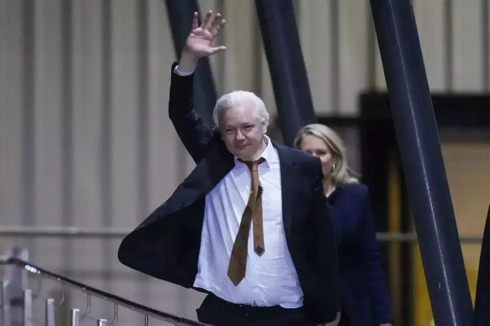 WikiLeaks founder Julian Assange waves after landing at RAAF air base Fairbairn in Canberra, Australia, Wednesday, June 26, 2024. (AP Photo/Rick Rycroft)