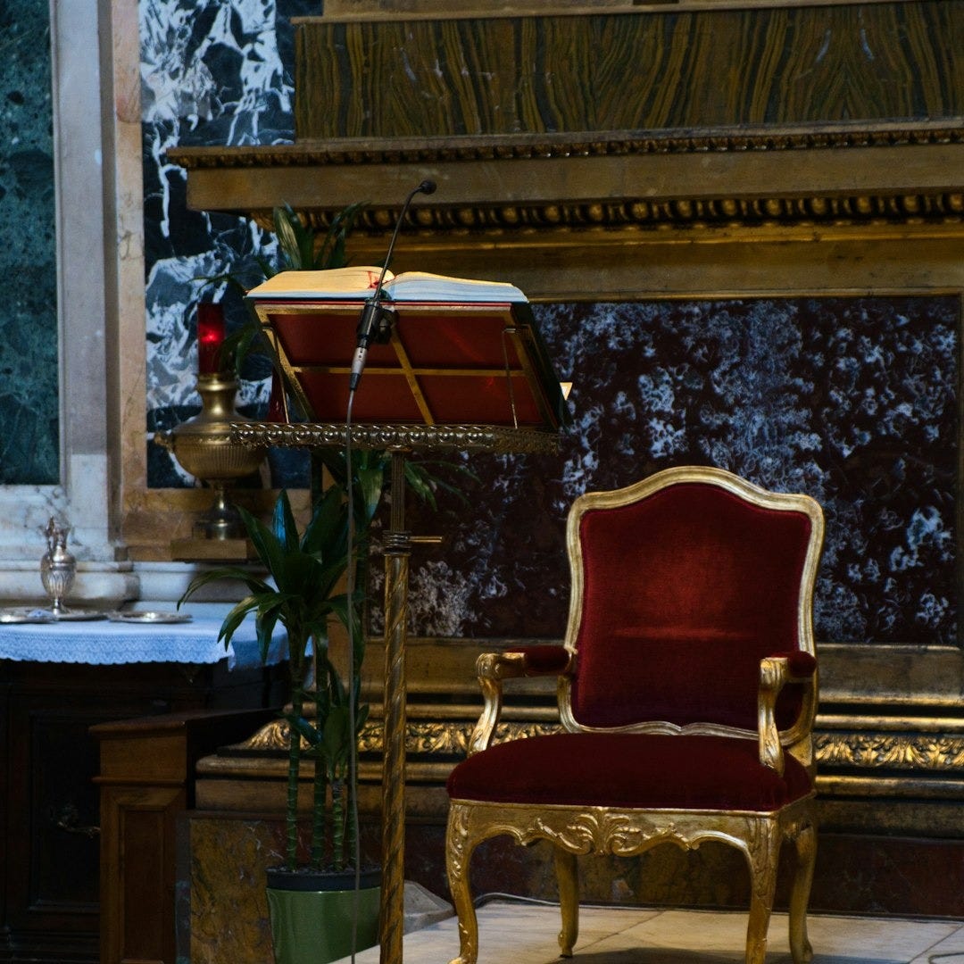 a red chair sitting on top of a carpet covered floor