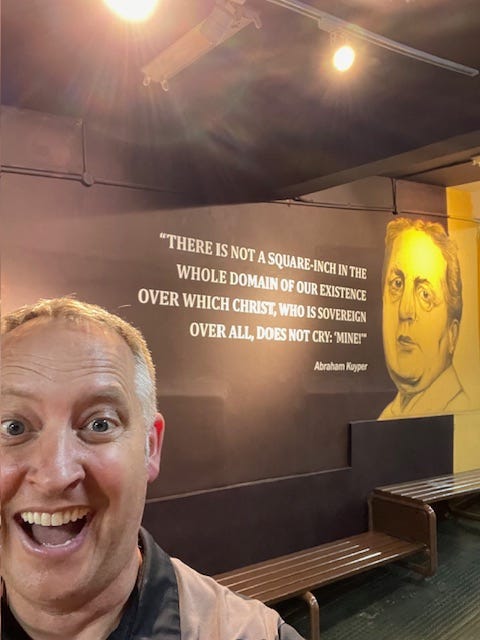 Dr. Dave in front of a quote by Abraham Kuyper: "There is not a square-inch in the whole domain of our existence over which Christ, who is sovereign overall, does not cry: 'Mine!'" Dr. Dave in front of a quote by Abraham Kuyper: "There is not a square-inch in the whole domain of our existence over which Christ, who is sovereign overall, does not cry: 'Mine!'"