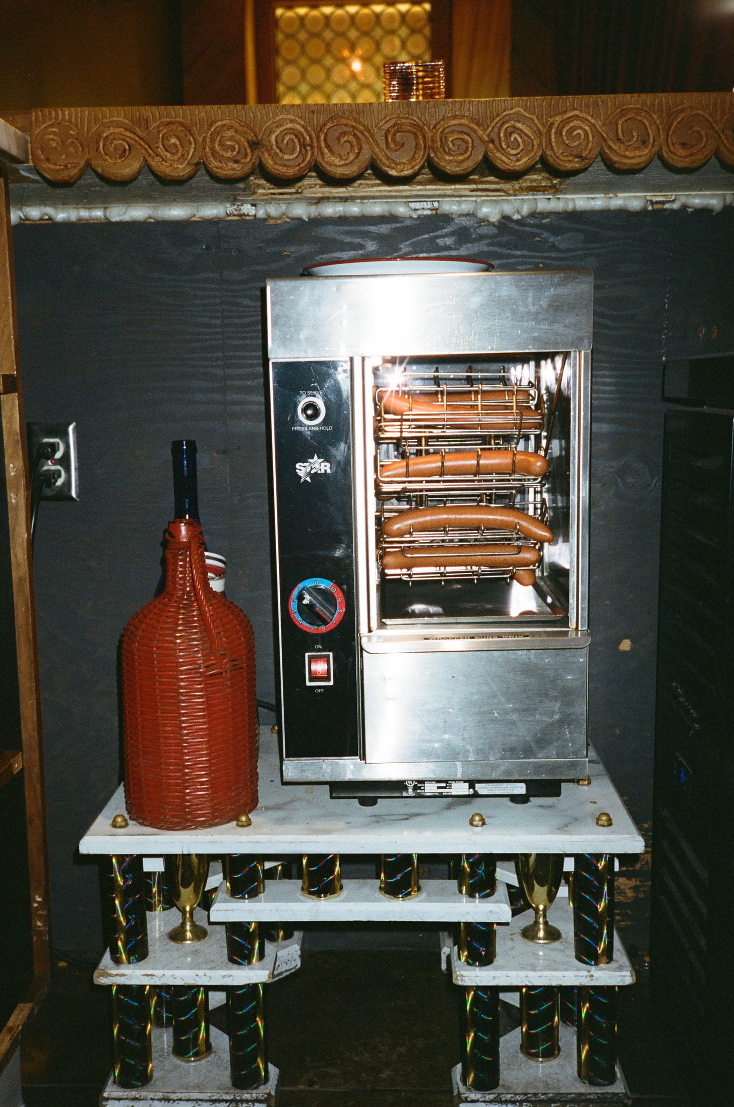 El Prado's hot dog broiler on a Ry Rocklen pedestal