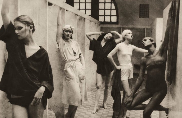 Photograph of five women standing and
posing in a bathhouse.