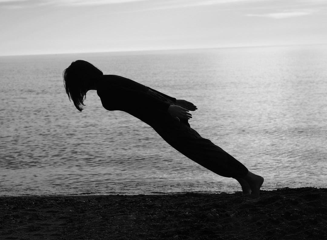 person doing gravity lean on the shore person doing gravity lean on the shore