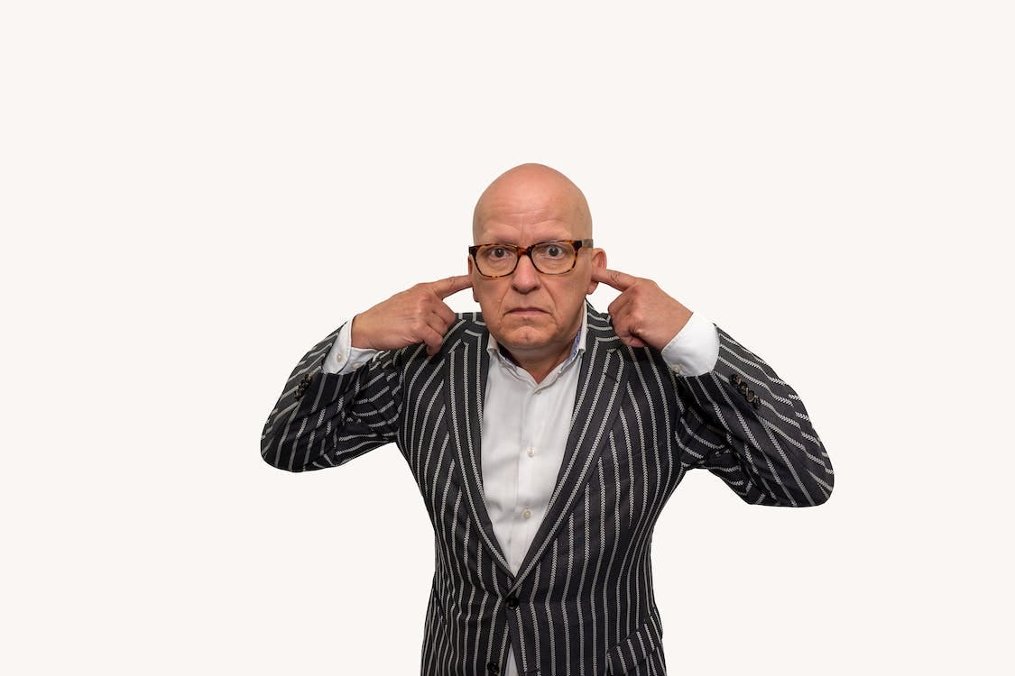 Free Bald Man Covering Ears with His Fingers Stock Photo