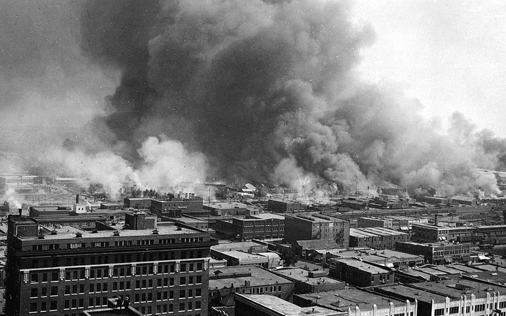 Black and white photo of flames and smoke rising over Tulsa in 1921