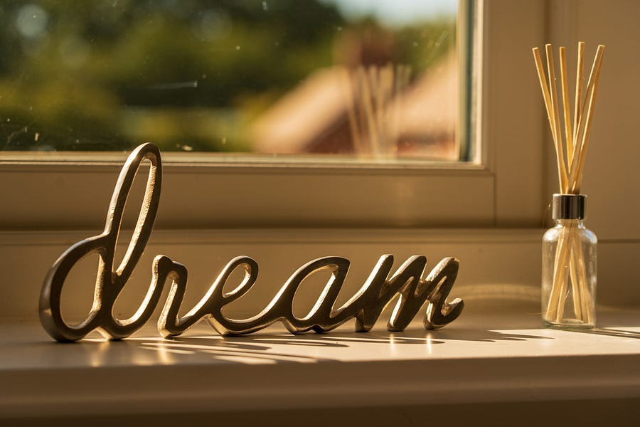 the word “dream” as a curio on a window sill.