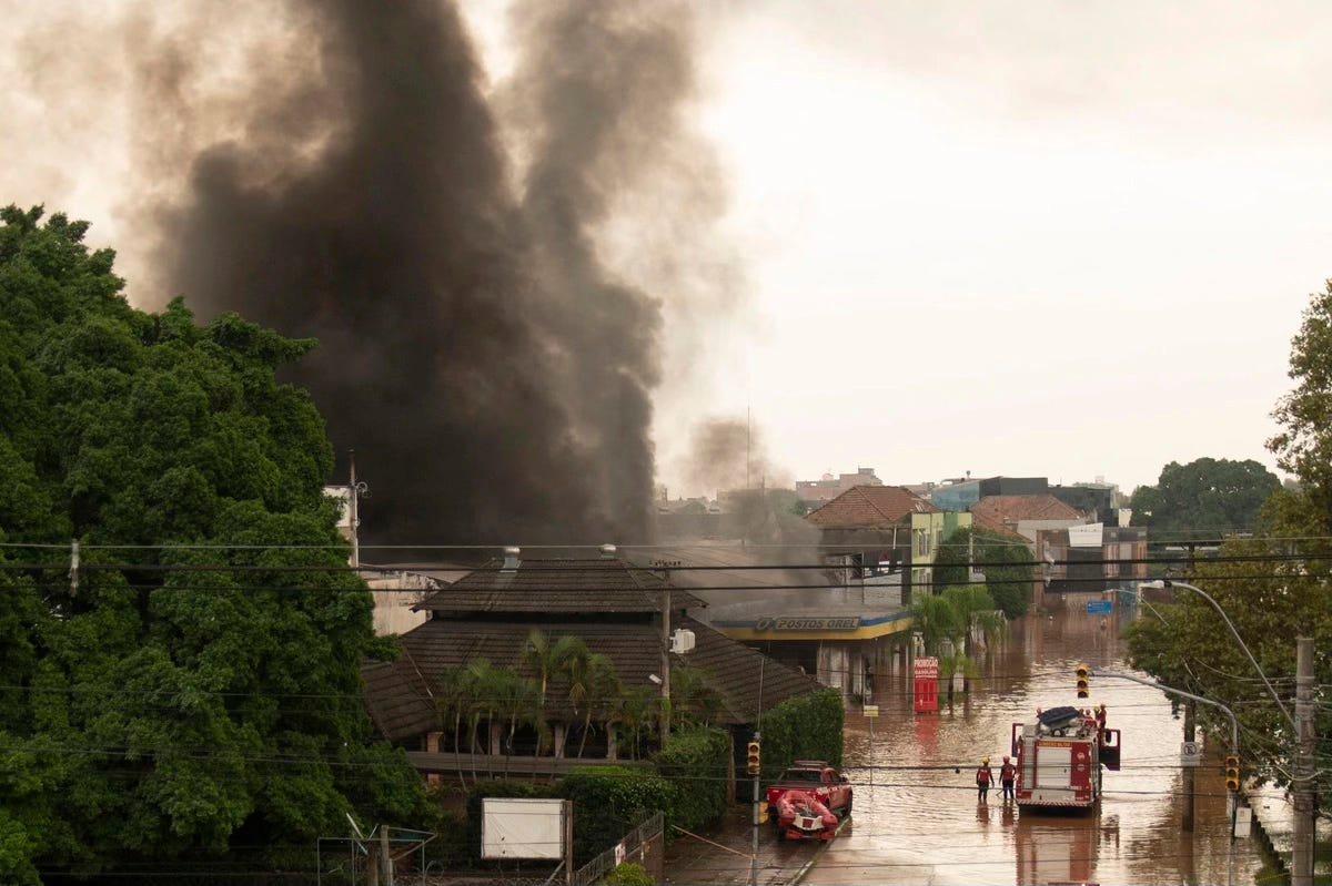 Smoke rises after an explosion at a flooded petrol station in Porto Alegre on May 4, 2024. Carlos Fabal / AFP / Getty