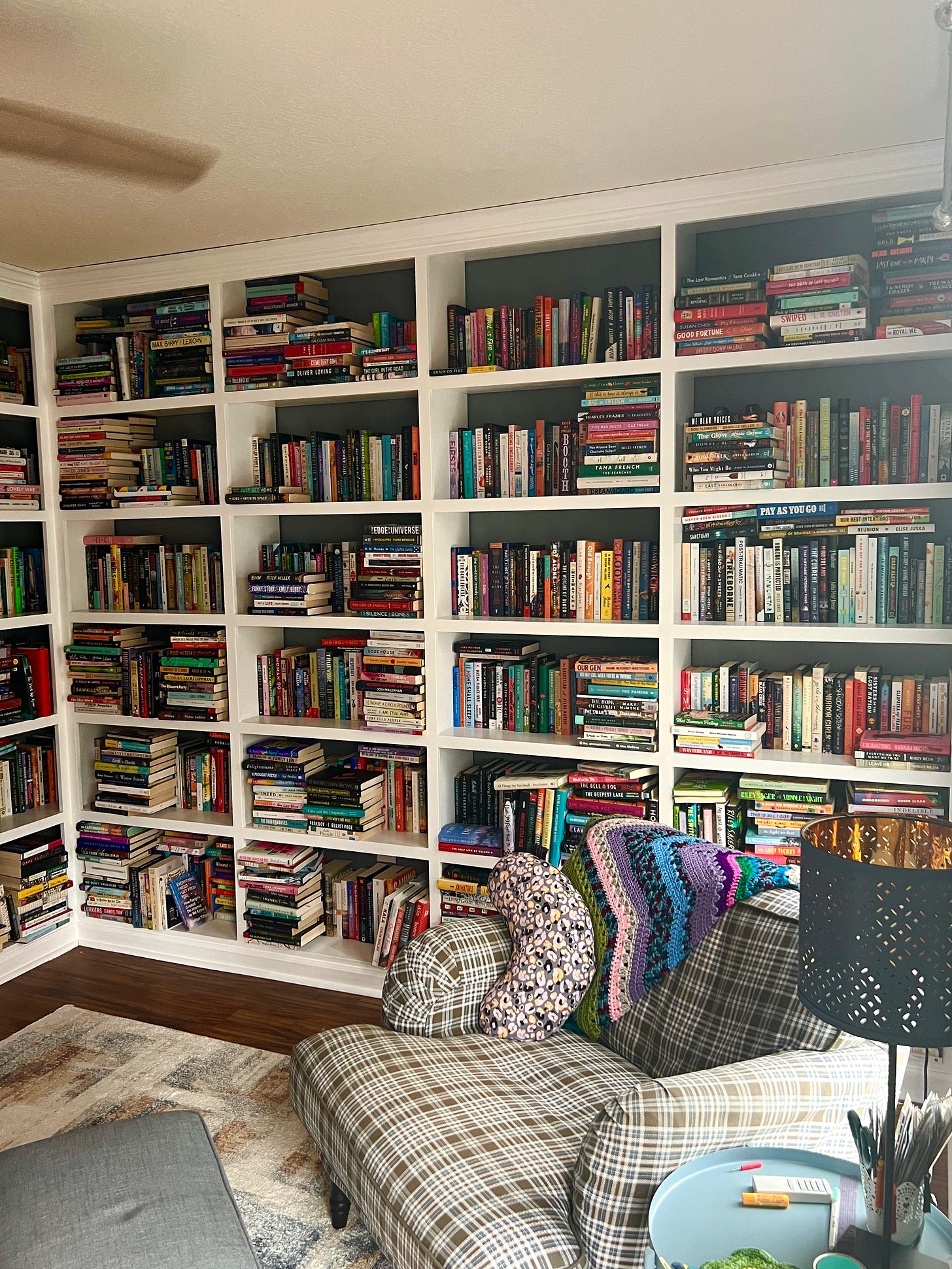 A room of built-in bookshelves stuffed to the max with books everywhere. 