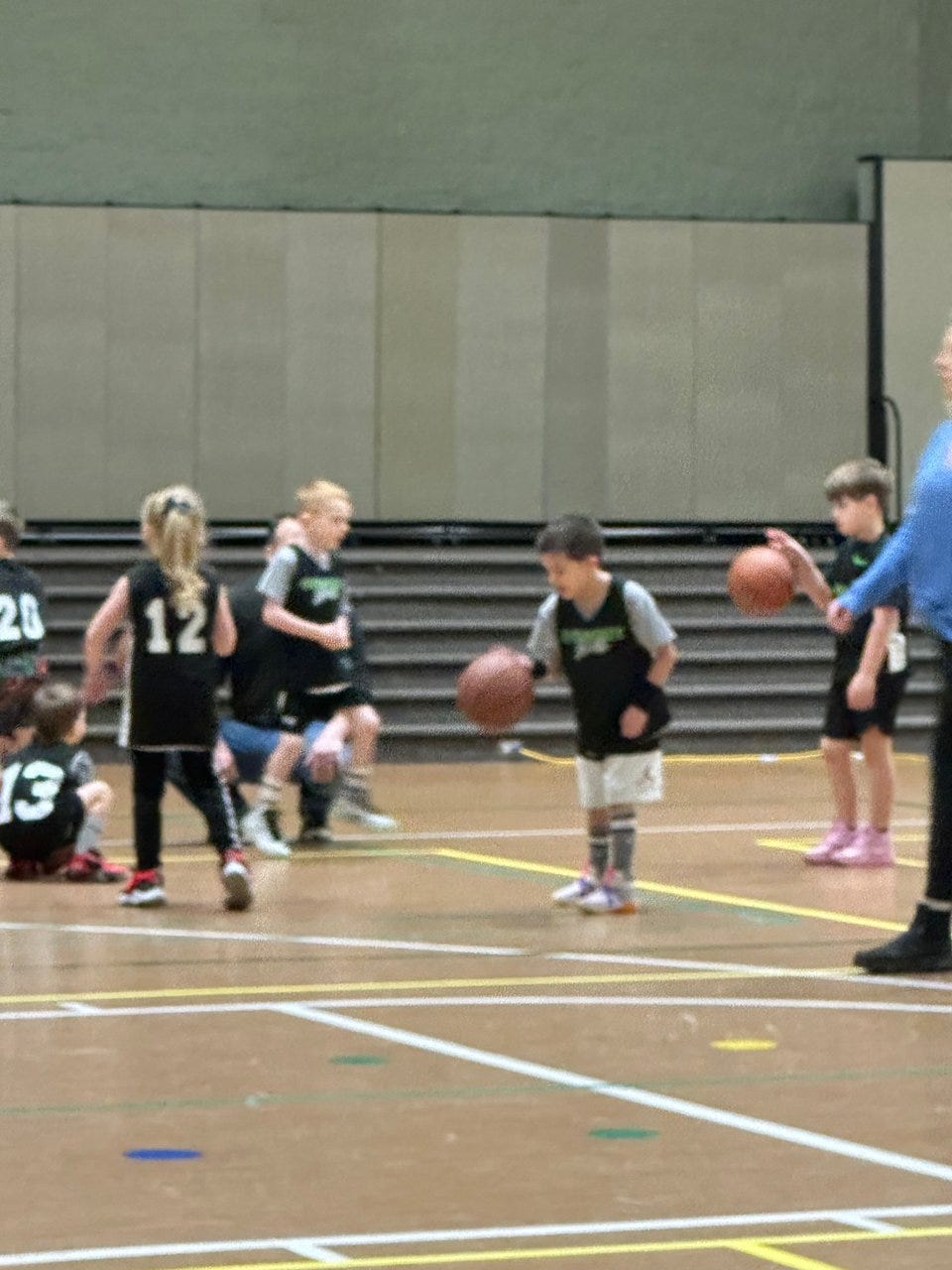 A group of young kids playing basketball