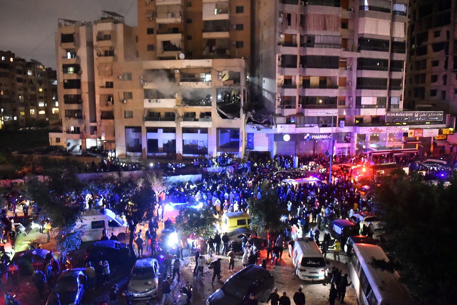People gather at the site of an alleged Israeli strike in Beirut.
