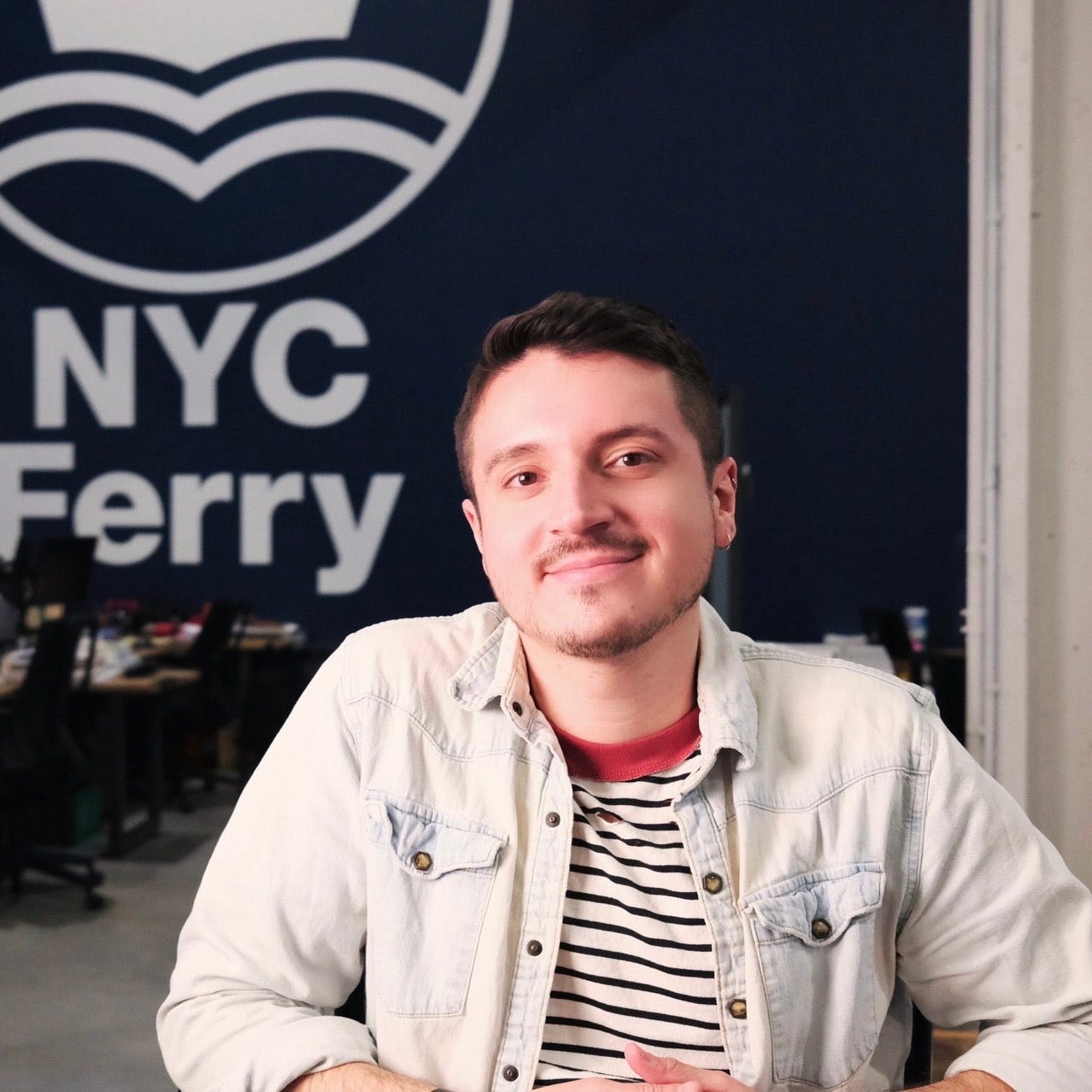 Photo of Franky Ponce in front of an NYC Ferry sign