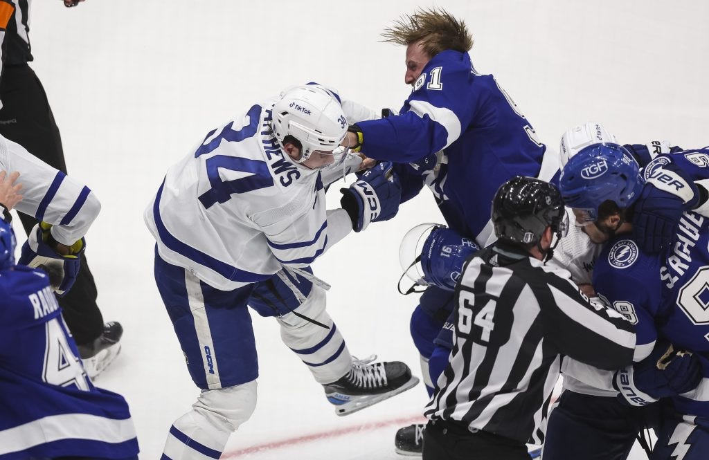Steven Stamkos of the Lightning (91) and Auston Matthews of the Maple Leafs (34) fight in the third period on April 22, 2023.