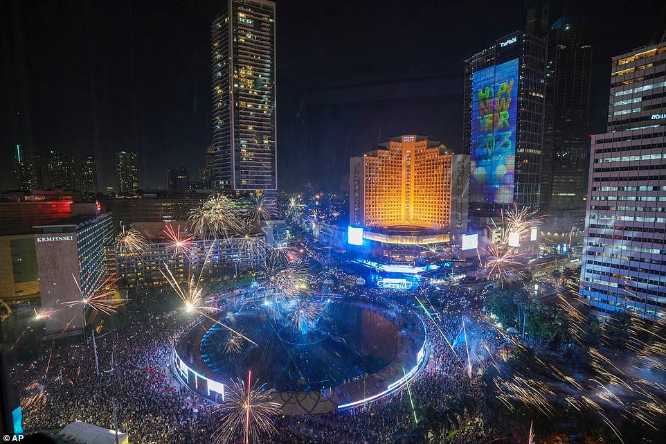 JAKARTA: Fireworks explode as thousands of people gather to watch, in the main business district on New Year's Eve in Jakarta, Indonesia