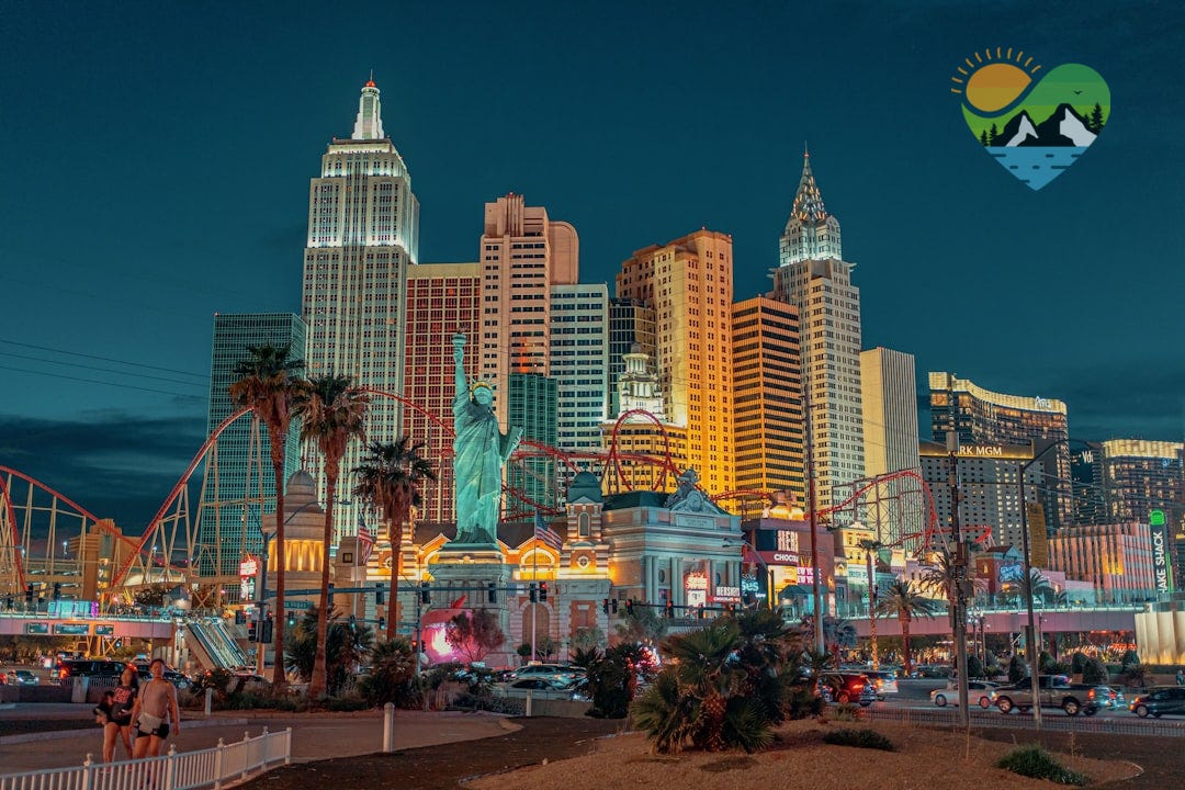 New York-New York Hotel and Casino with a statue and a body of water