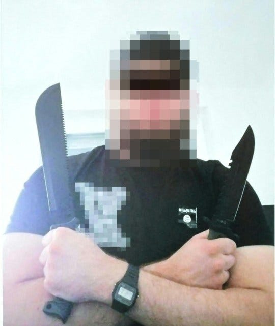 A man arrested in connection with an Islamist attack plot that caused the cancellation of the Vienna leg of a tour by Taylor Swift, holds two large knives with arms crossed