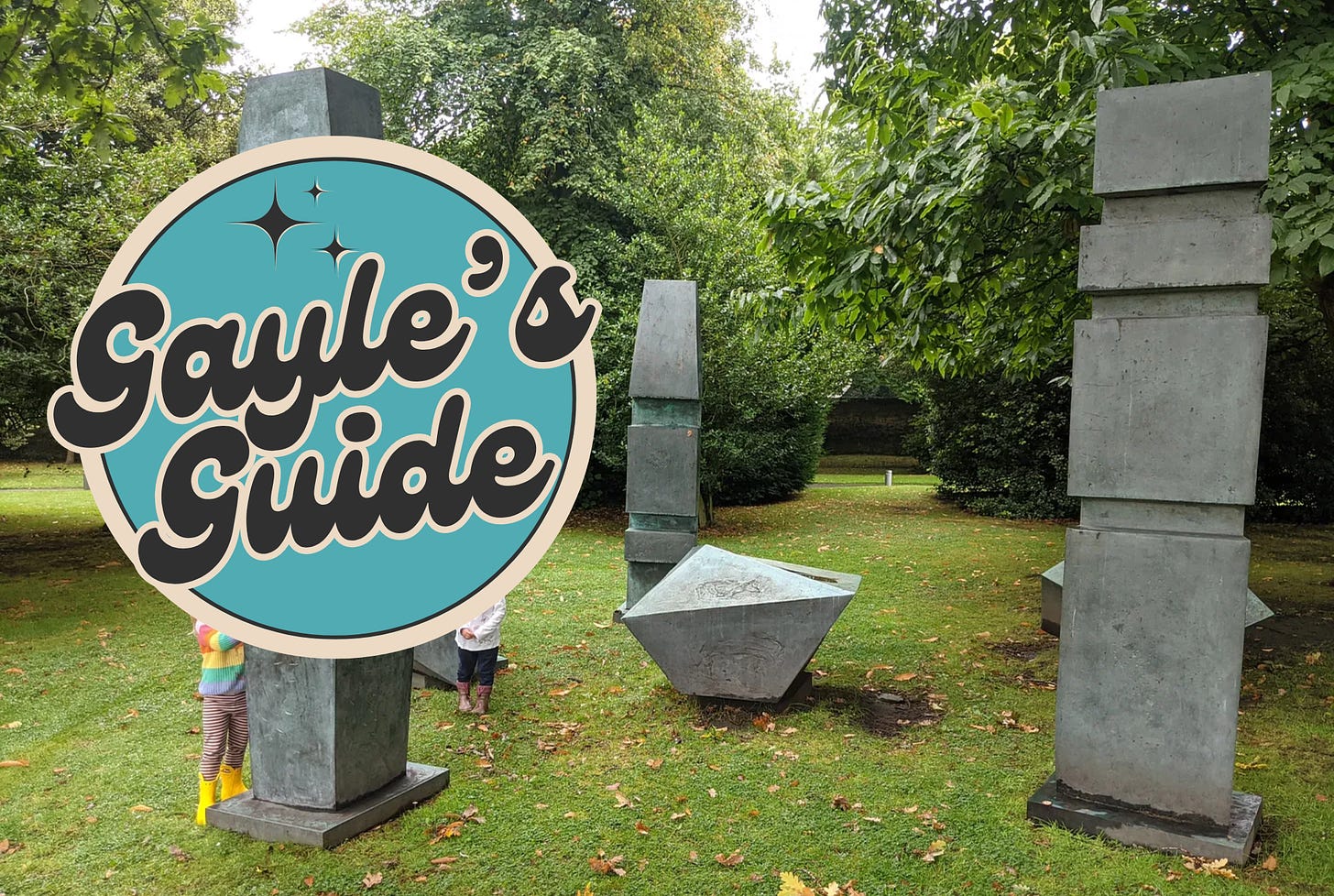 outdoor modern sculptures with Gayle's Guide logo partially obscuring two children