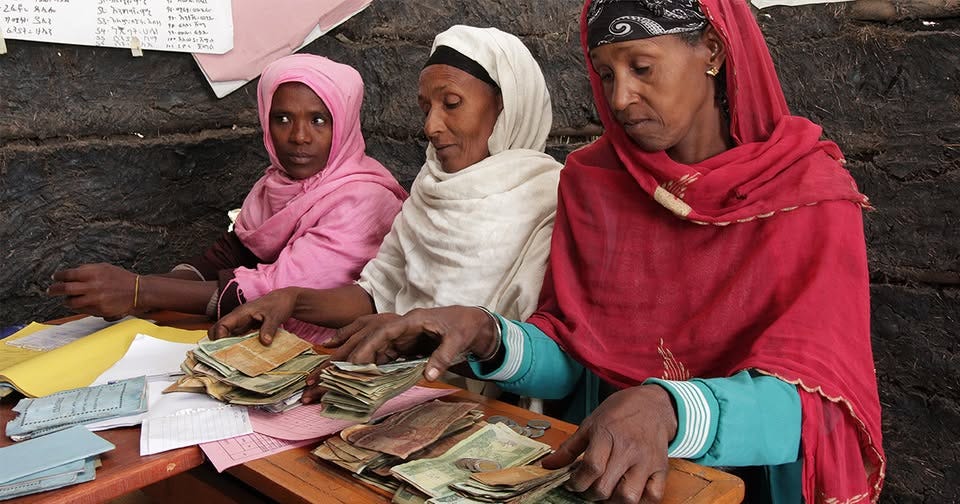Pictured here are members of Pictured is three women members of the Yidibisha Rural Savings and Credit Cooperative administering the affairs of their group - disbursing loans and collecting savings on behalf of their members.
