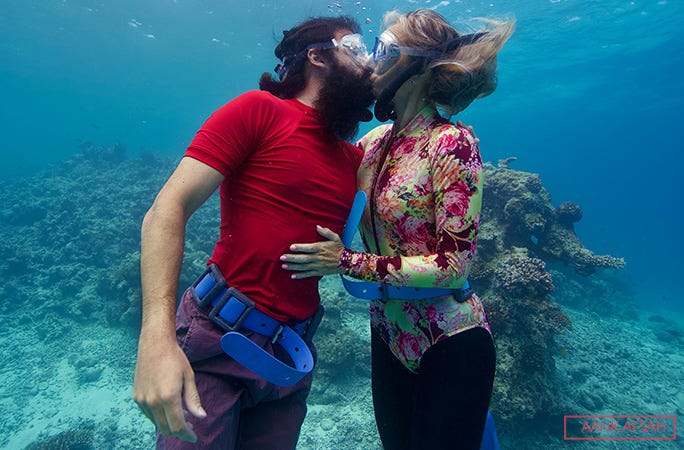 beth and miles practice their underwater kiss