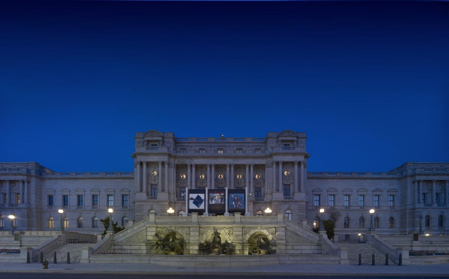 a night time view of the outside of the library of congress
