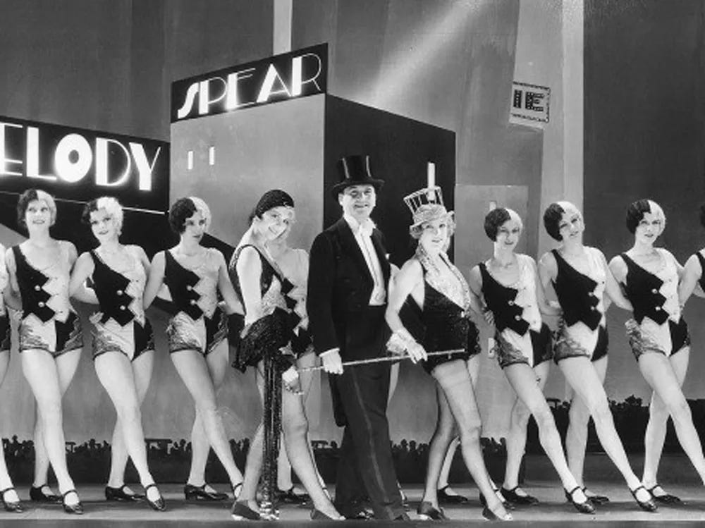 Anita Page, Charles King, Bessie Love, & chorus girls in a still from The Broadway Melody