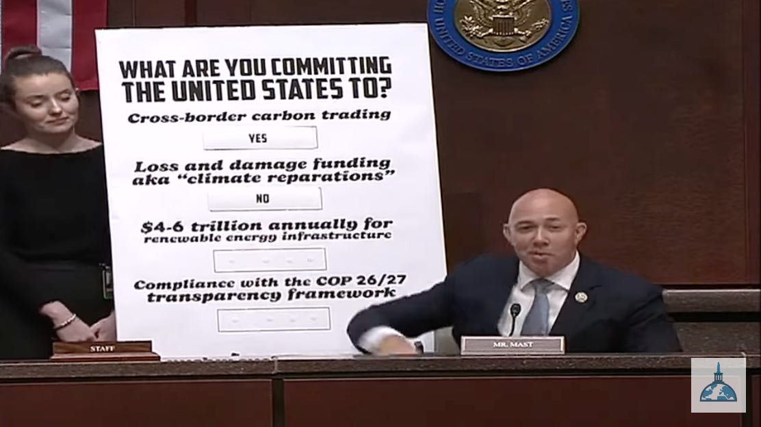 a bald guy smirks in front of a chart